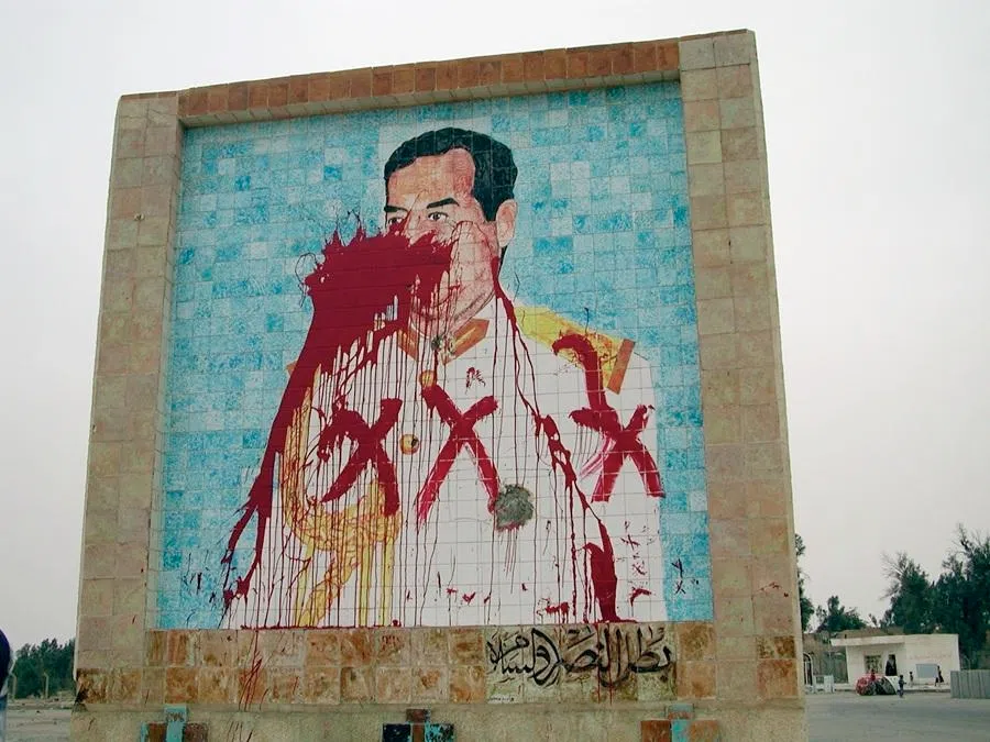 A defaced mosaic of Iraqi president Saddam Hussein in the port city of Umm Qasr, Iraq.