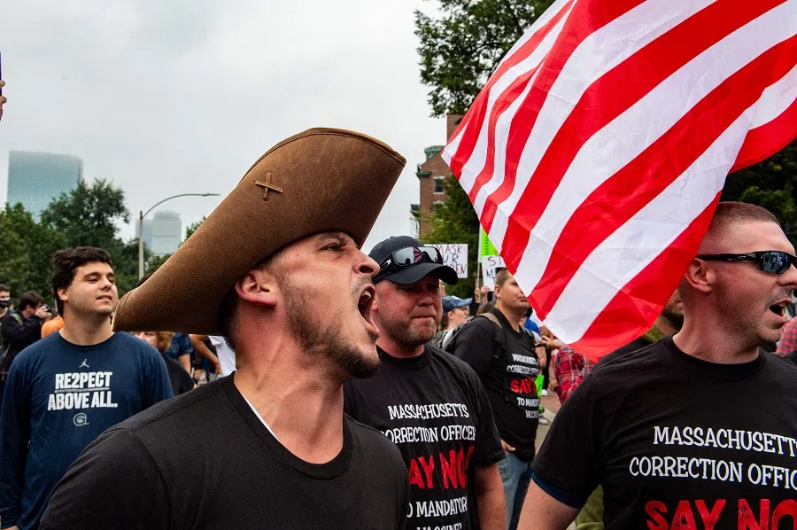 Demonstrators chant "USA" as they gather outside the Massachusetts State House in Boston, US, to protest Covid-19 vaccination and mask mandates. (Joseph Prezioso/AFP)