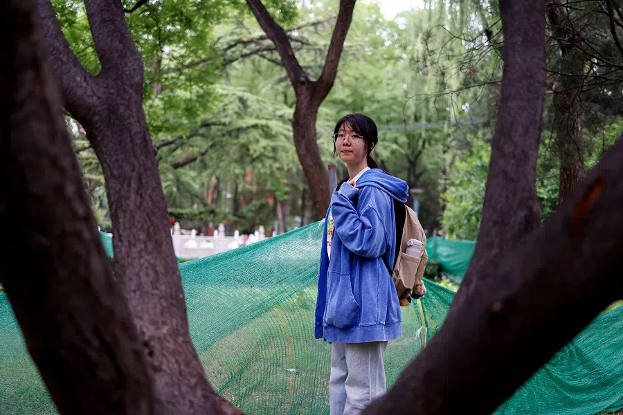 Postgraduate student Lainey, who is waiting to resume visa process to study a PhD in the US, walks out of her university campus, during an interview with Reuters, in Beijing, China, on 30 May 2025. (Tingshu Wang/Reuters)