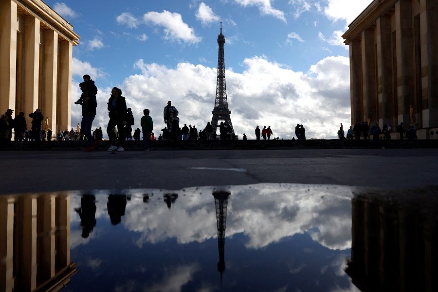 People take in views of the Eiffel Tower from the Trocadero, Paris, France, on 29 October 2023. (Peter Cziborra/Reuters)