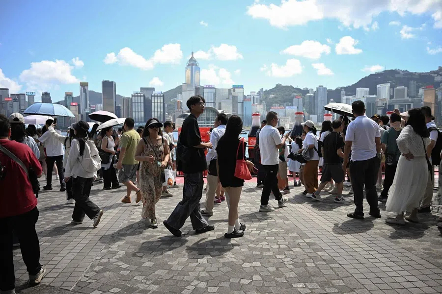 People visit Victoria Harbour in Hong Kong on 2 October 2025. (Peter Parks/AFP)