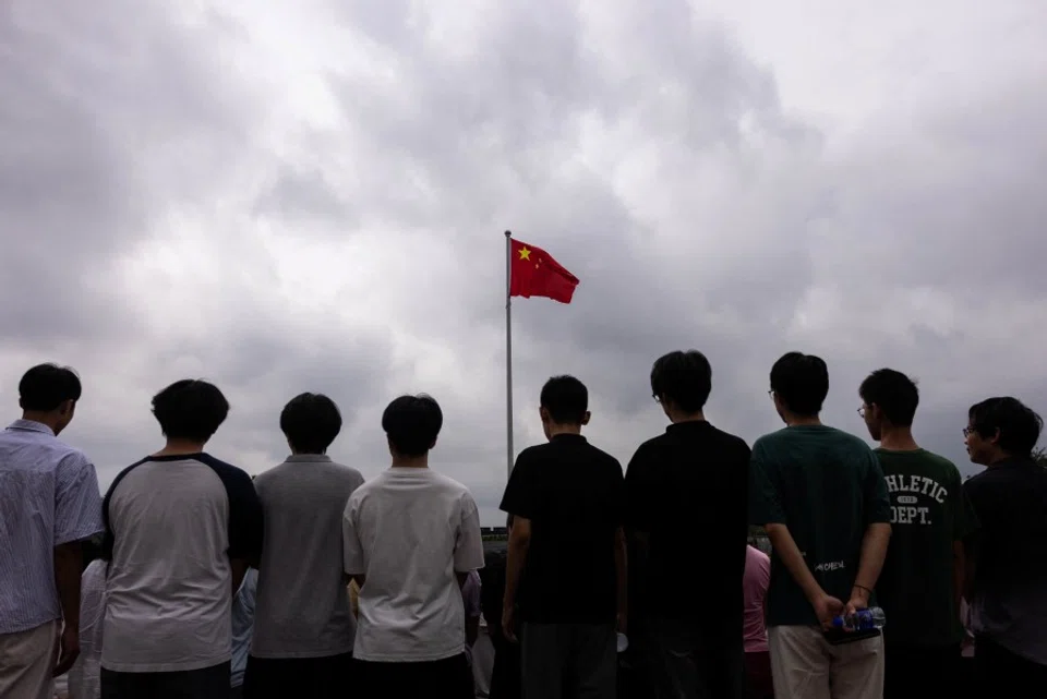Young people pose for a photograph in Beijing, China, on 19 August 2025. (Maxim Shemetov/Reuters)