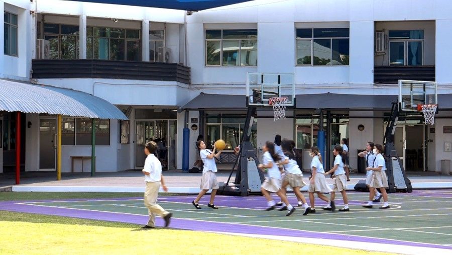 Children at the basketball court in Harrow International School Thailand.