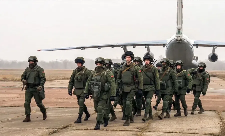 This handout image grab taken and released by the Russian Defence Ministry on 8 January 2021 shows Belarus' paratroopers leaving a military cargo plane after landing in Kazakhstan. (Handout/Russian Defence Ministry/AFP)