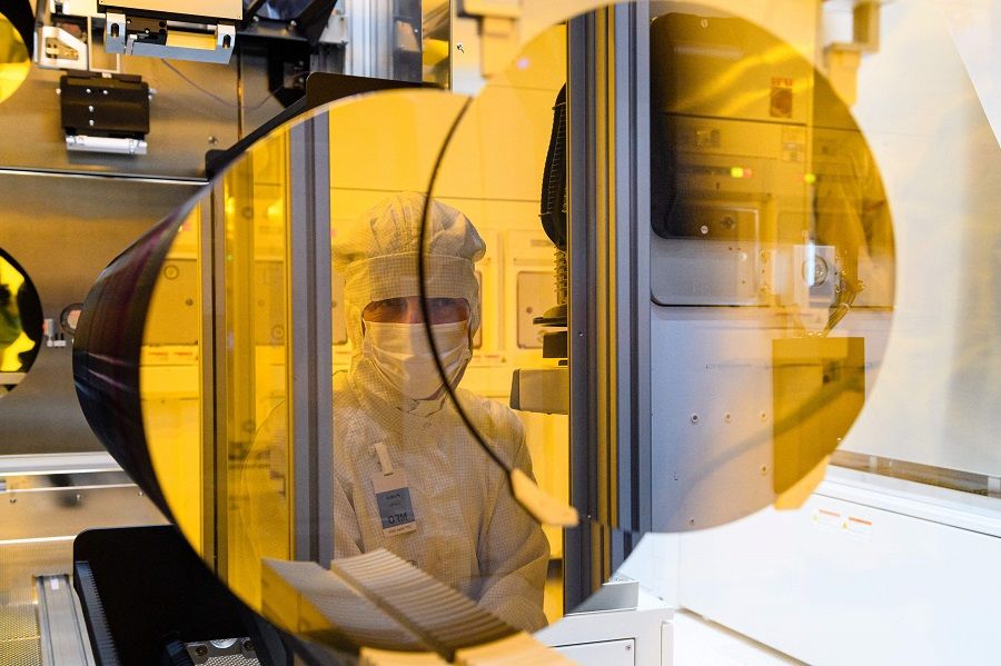 This file photo taken on 31 May 2021 shows an employee of the semiconductor manufacturer Bosch working in a clean room during the preparations for the series production of semiconductor chips on innovative 300-millimetre wafers in Dresden, Germany. (Jens Schlueter/AFP)