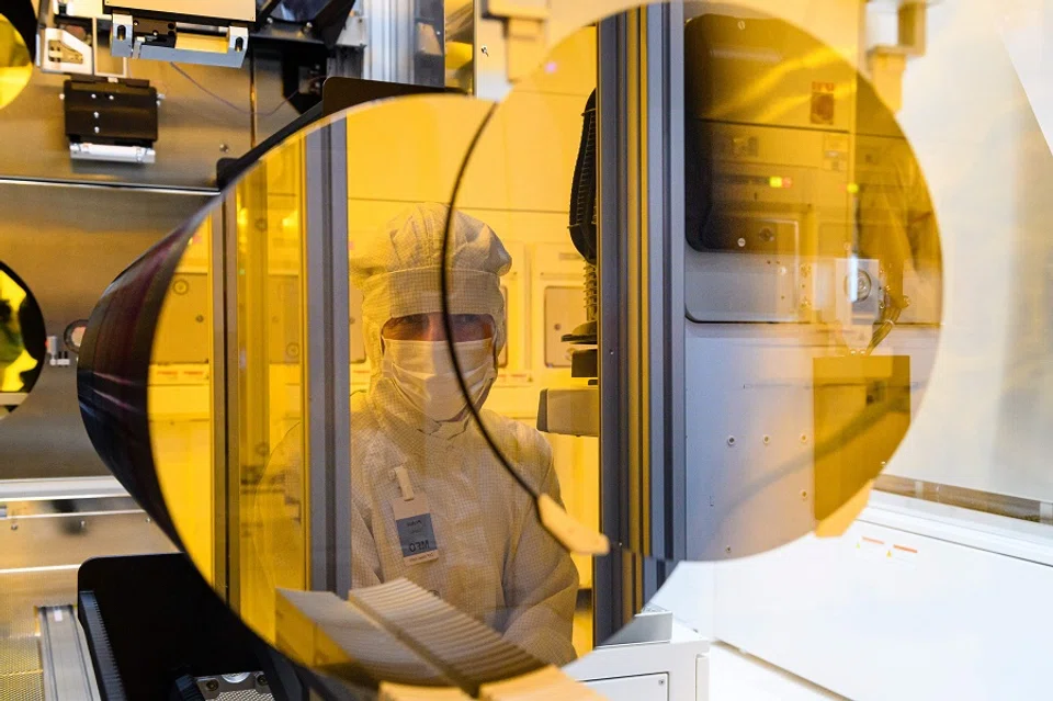 This file photo taken on 31 May 2021 shows an employee of the semiconductor manufacturer Bosch working in a clean room during the preparations for the series production of semiconductor chips on innovative 300-millimetre wafers in Dresden, Germany. (Jens Schlueter/AFP)