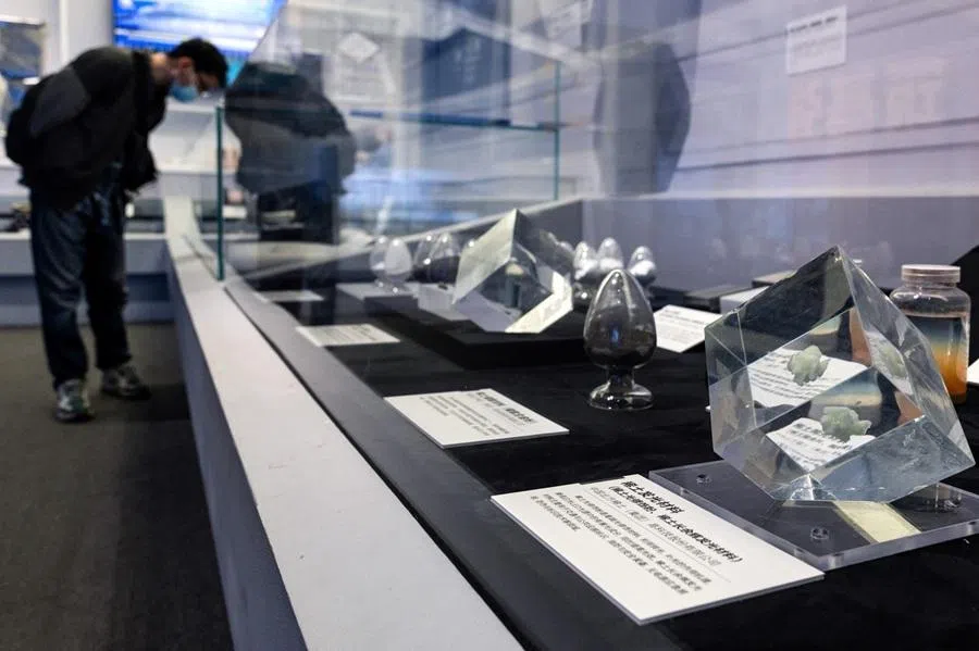 A man looks at the samples of rare‑earth luminescent materials displayed at the rare earth elements production section of the exhibition on China’s manufacturing achievements at the National Museum in Beijing, China, 24 March 2026.