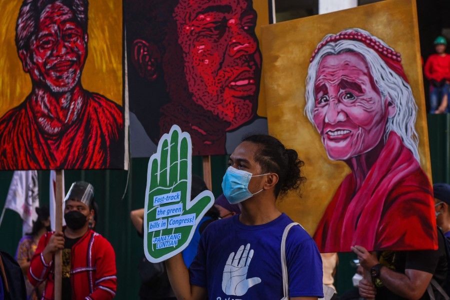 People participate in a rally during a global day of action on climate change in Manila on 6 November 2021, as world leaders attend the COP26 UN Climate Change Conference in Glasgow. (Maria Tan/AFP)