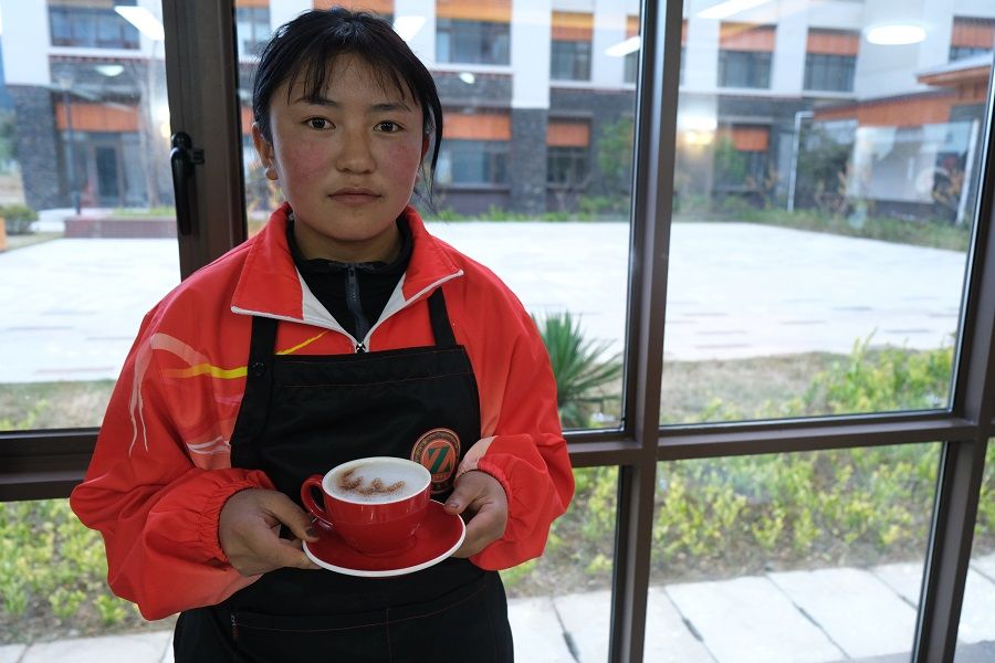 Luo Zhuo with a cup of hand-brewed coffee.