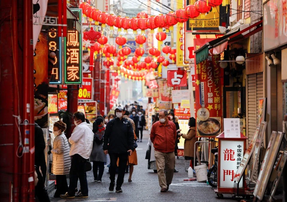 Passersby wearing protective face masks walk on the street at Yokohama's China town, amid the coronavirus disease (COVID-19) outbreak, in Yokohama, south of Tokyo, Japan, 1 December 2020. (Issei Kato/REUTERS)