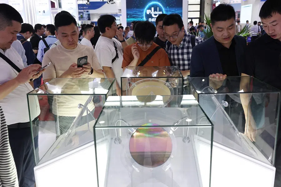 People look at semiconductor products at the SEMICON China semiconductor exhibition in Shanghai on 26 March 2025. (AFP)