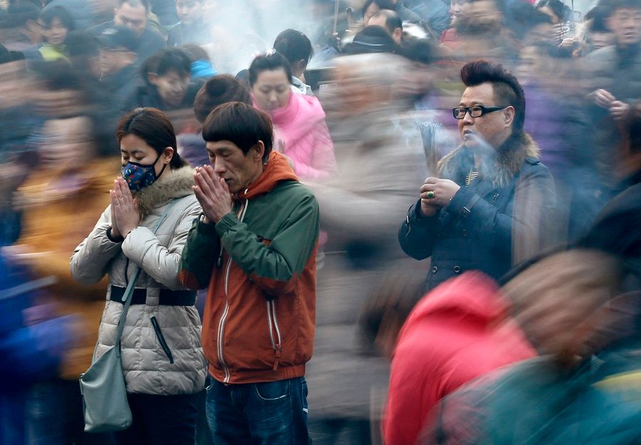 People pray for good fortune on the first day of the Chinese Lunar New Year at Yonghe Lama Temple, in Beijing, China, 19 February 2015. (Kim Kyung-Hoon/Reuters)