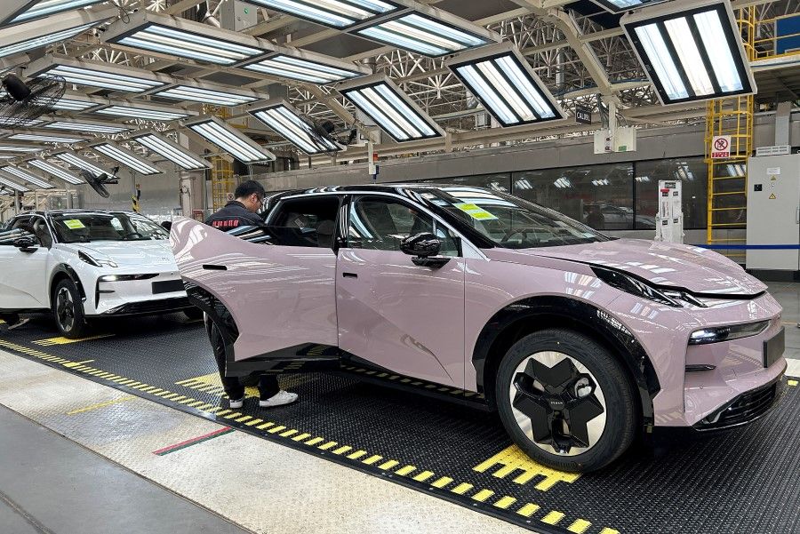 Staff members work on an assembly line manufacturing Zeekr X trial production models, at the Geely's plant in Chengdu, Sichuan province, China, on 13 April 2023. (Zoey Zhang/Reuters)