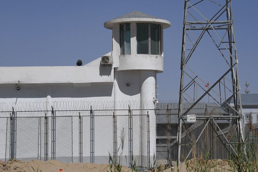 This file photo taken on 31 May 2019 shows a watchtower on a high-security facility near what is believed to be a re-education camp where mostly Muslim ethnic minorities are detained, on the outskirts of Hotan, Xinjiang, China. (Greg Baker/AFP)
