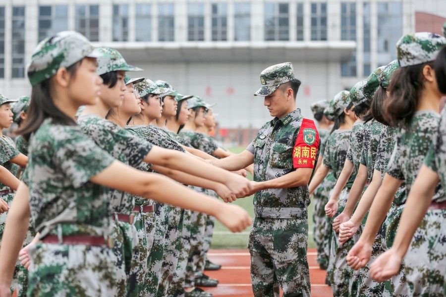 This photo taken on 26 August 2020 shows high school students taking part in a military education and training session ahead of the new semester in Yongzhou, in China's central Hunan province. (STR/AFP)