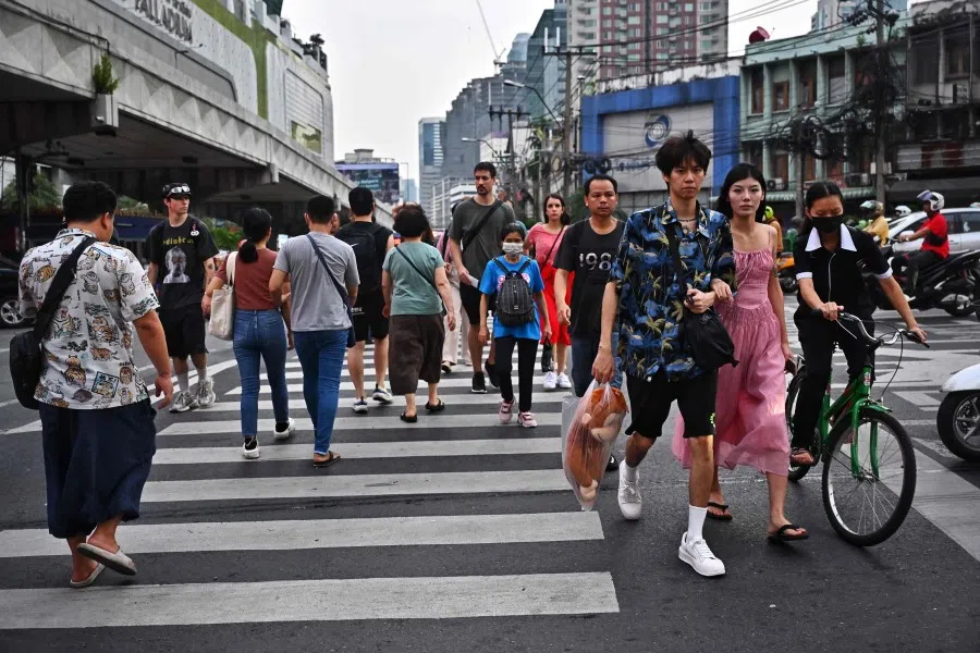 People use a pedestrian crossing in Bangkok on 16 October 2023. (Lillian Suwanrumpha/AFP)