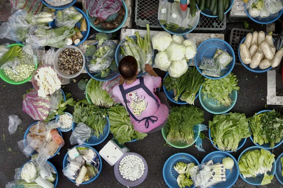 A vendor sorts her vegetables at Wanda Road traditional market in Taipei, Taiwan, on 25 January 2022. (Sam Yeh/AFP)