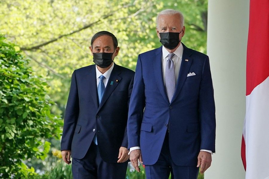 US President Joe Biden and Japan's Prime Minister Yoshihide Suga walk through the Colonnade to take part in a joint press conference in the Rose Garden of the White House in Washington, DC on 16 April 2021. (Mandel Ngan/AFP)
