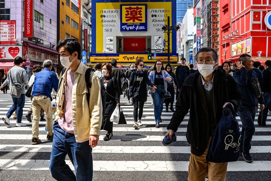 People walk in the shopping area of Tokyo’s Akihabara district on 11 April 2024.  (Philip Fong/AFP)
