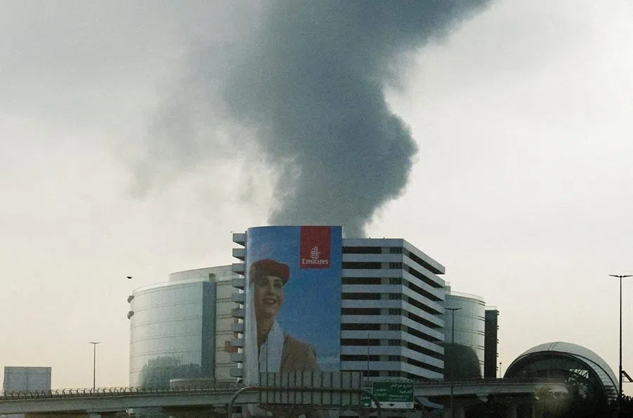 Smoke rising from an area near the Dubai International Airport is seen through the windshield of a vehicle, after a drone attack hit a fuel tank, according to Dubai authorities, amid the US-Israel conflict with Iran, in Dubai, UAE, 16 March 2026. (Stringer/Reuters)
