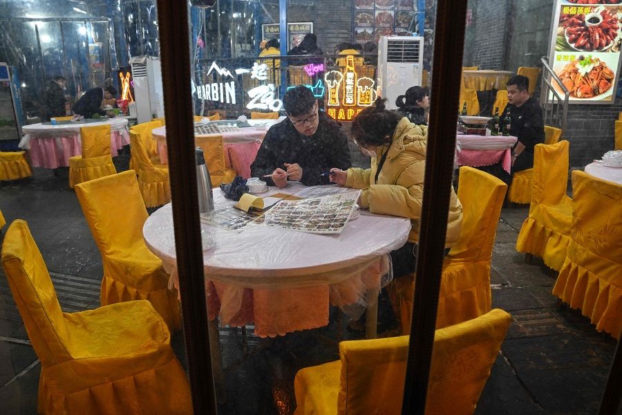 People dine at a restaurant on the eve of the Lunar New Year in Wuhan, Hubei province, China, on 21 January 2023. (Hector Retamal/AFP)