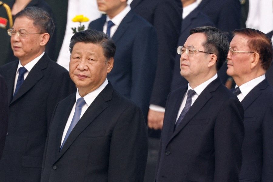 Chinese President Xi Jinping (second from left) and Director of the General Office of the Central Committee Ding Xuexiang attend a wreath laying ceremony on Tiananmen Square to mark Martyrs' Day on the eve of the National Day in Beijing, China, 30 September 2022. (Thomas Peter/Reuters)