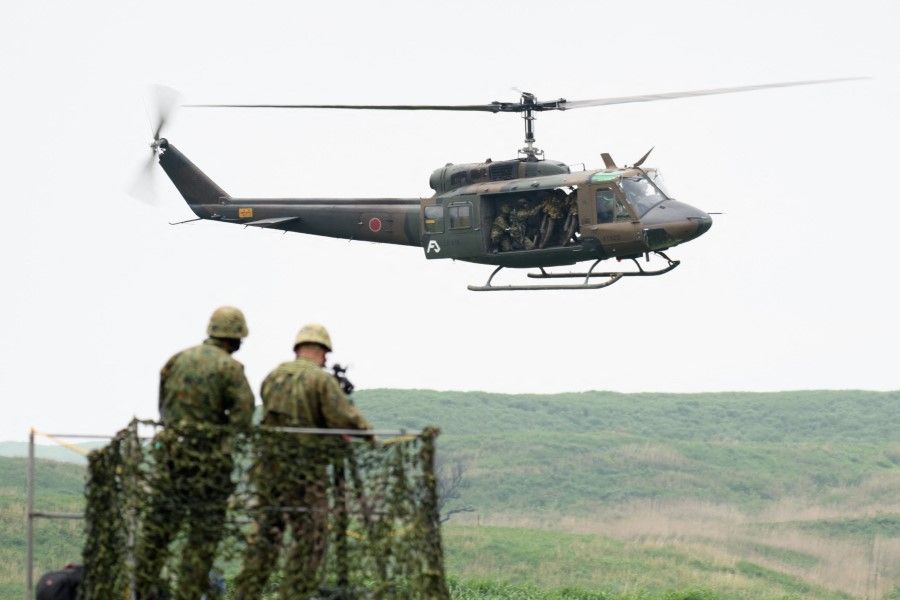 A UH-1J helicopter flies during a live fire exercise at Japan's Ground Self-Defense Forces (JGSDF) training grounds in the East Fuji Manuever Area in Gotemba on 22 May 2021. (Akio Kon/AFP)