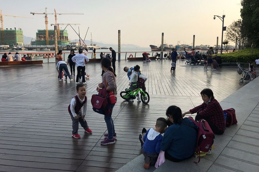 Children play at a waterfront in Shekou area of Shenzhen, Guangdong province, China on 15 March 2021. (David Kirton/Reuters)