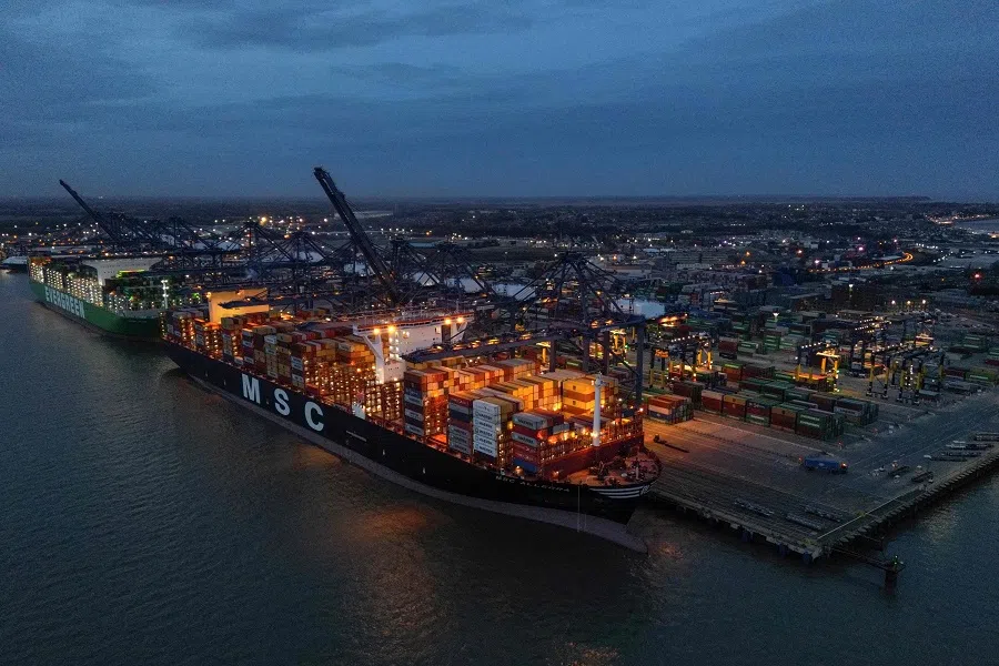 An aerial picture shows stacks of containers pictured on the deck of the MSC Allegra (right) and Ever Atop (left) container ships, docked beside container cranes at the UK's largest freight port, in Felixstowe on the East coast of England, on 27 January 2024. Hundreds of cargo ships and tankers are being rerouted around the southern tip of Africa to avoid Houthi attacks in the Red Sea. (Ben Stansall/AFP)