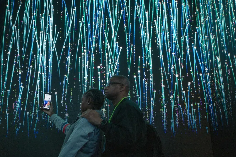 People watch an immersive video introduction to Qualcomm 5G technology at the Las Vegas Convention Center during CES 2019 in Las Vegas, January 2019. (David McNew/AFP)