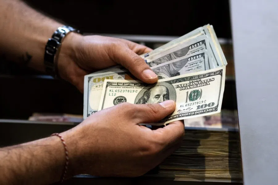 An employee counts US 100 dollar banknotes in Istanbul, Turkey, on 8 June 2023. (Moe Zoyari/Bloomberg)