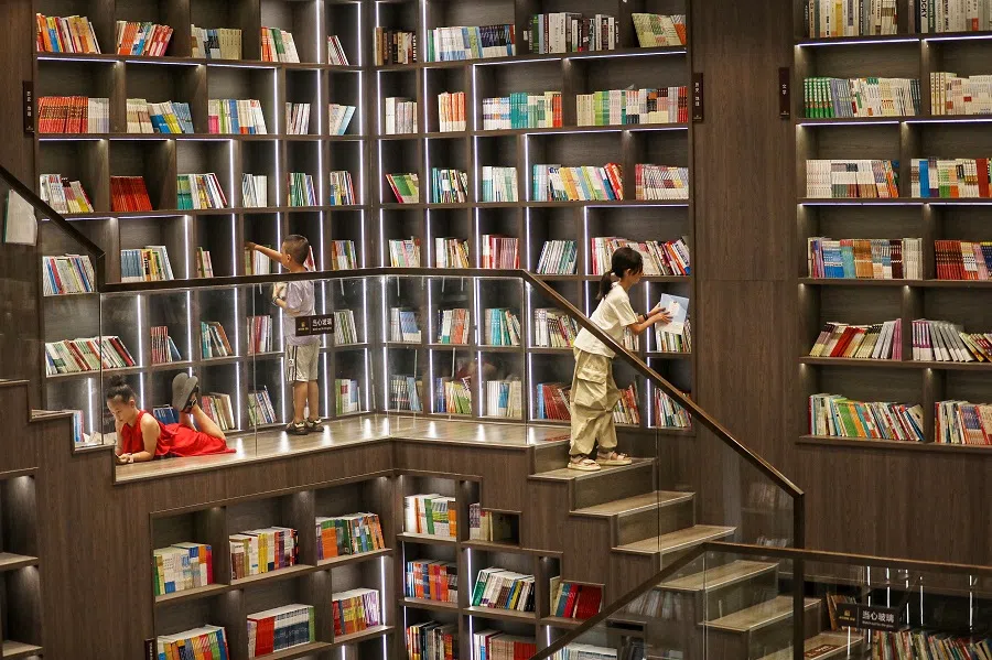 Children read at a bookstore in Zixing, in central China’s Hunan province on 12 August 2024. (AFP)