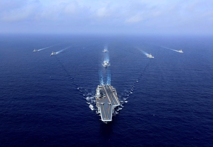This file photo taken on 18 April 2018 shows China's aircraft carrier, the Liaoning (centre), on its way during a drill at sea. (STR/AFP)
