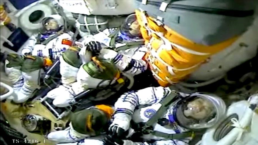 Chinese astronauts Nie Haisheng, Liu Boming, and Tang Hongbo are seen inside the Shenzhou-12 spacecraft as China launches the spacecraft via the Long March-2F Y12 carrier rocket on its first crewed mission to build the country's space station from Jiuquan Satellite Launch Center near Jiuquan, Gansu province, China, in this still image taken from a video on 17 June 2021. (CCTV via Reuters)