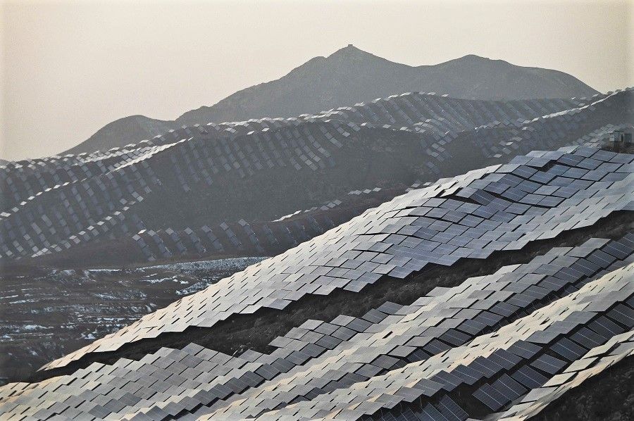 This photo taken on 15 November 2021 shows solar panels on hillsides at Xuanhua in Zhangjiakou, Hebei province, China. (Greg Baker/AFP)