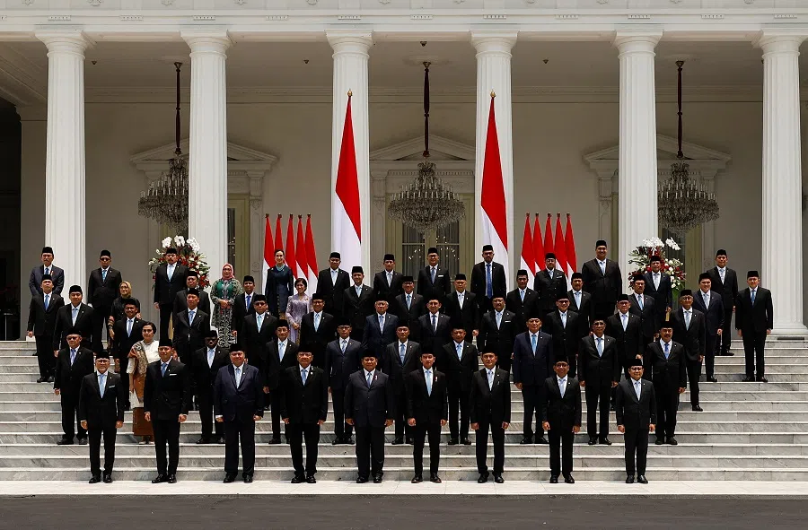 Indonesian President Prabowo Subianto, Vice President Gibran Rakabuming Raka, and newly appointed cabinet ministers pose for photographs after the inauguration of the new cabinet, at the Presidential Palace in Jakarta, Indonesia, on 21 October 2024. (Willy Kurniawan/Reuters)