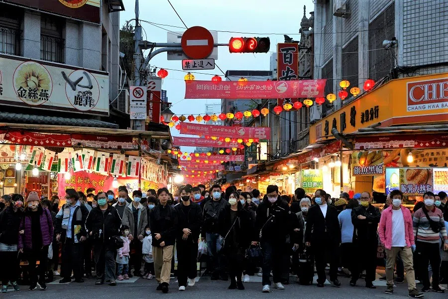 People shop for festive goods ahead of the Lunar New Year in Taipei, Taiwan, 7 January 2023. (Ann Wang/Reuters)