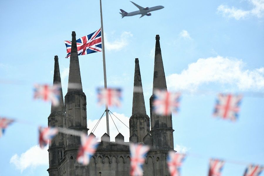 A Union Jack flies half mast at Windsor Castle on 18 September 2022, following the death of Queen Elizabeth II on 8 September. (Stephane de Sakutin/AFP)