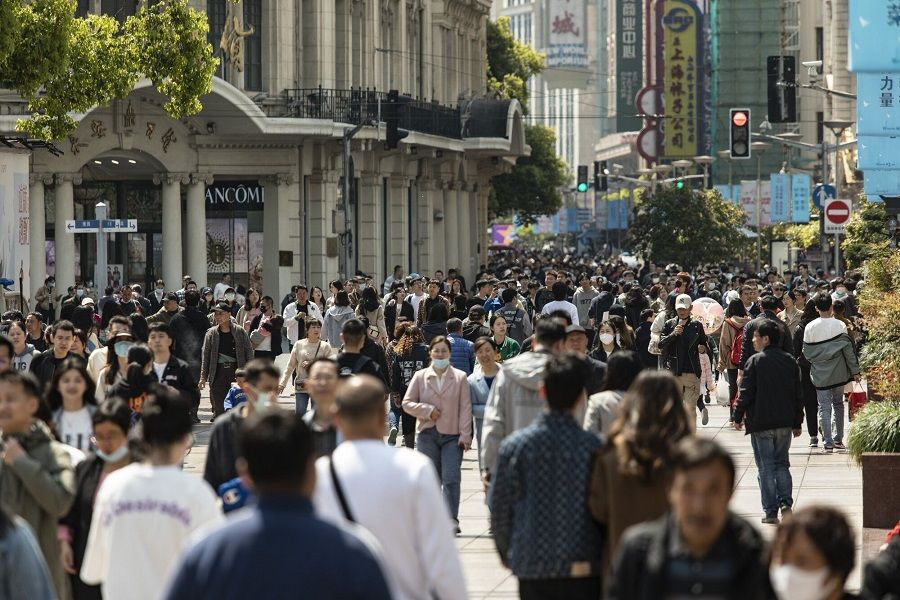 Shoppers walk down Nanjing East Road, one of the city's main commercial and tourist area, in Shanghai, China, on 8 April 2023. (Qilai Shen/Bloomberg)
