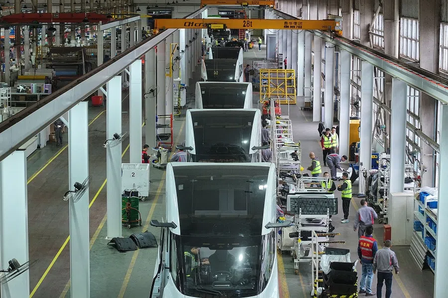 This photo taken on 18 November 2024 shows employees at a factory in Suzhou, in eastern China’s Jiangsu province. (AFP)