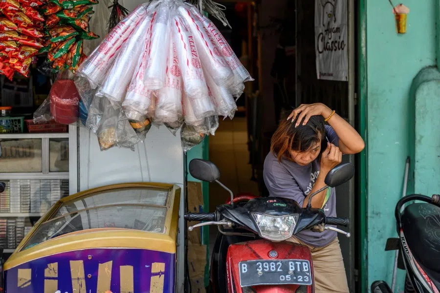 A Chinese ethnic woman at her shop in Chinatown in Jakarta, 7 May 2020. (Bay Ismoyo/AFP)