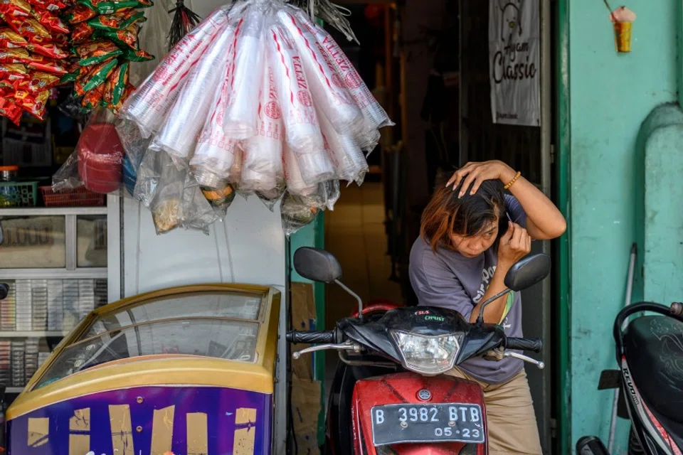 A Chinese ethnic woman at her shop in Chinatown in Jakarta, 7 May 2020. (Bay Ismoyo/AFP)