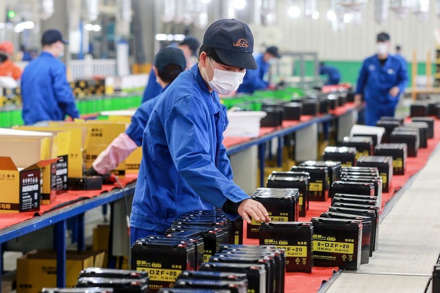 This photo taken on 30 March 2020 shows an employee working on a battery production line at a factory in Huaibei, Anhui, China, after work and production resumed. (STR/AFP)