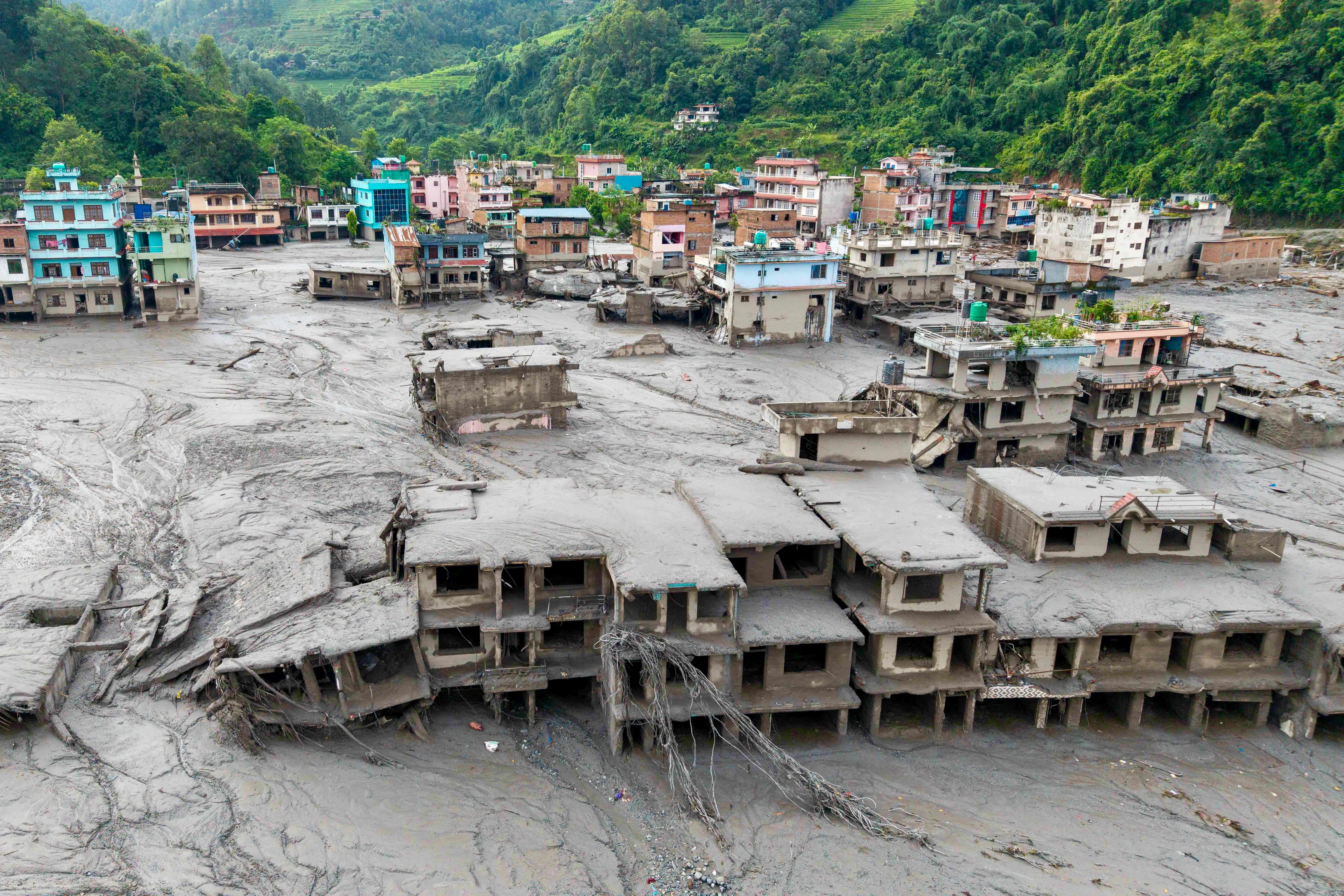 An aerial view shows houses lying deluged in sludge after flash floods at Devighat, Bidur Municipality in Nepal's Nuwakot district on 27 August 2026.