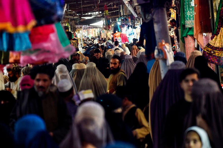 People walk along a women's clothing market in Kandahar, Afghanistan on 1 October 2020. (Wakil Kohsar/AFP)