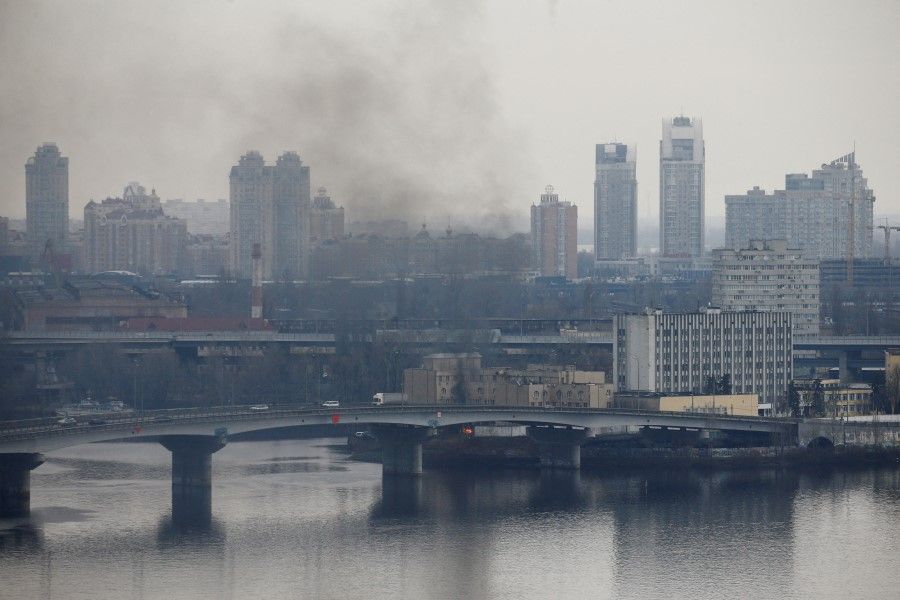 Smoke rises from the territory of the Ukrainian defence ministry's unit, after Russian President Vladimir Putin authorised a military operation in eastern Ukraine, in Kyiv, Ukraine, 24 February 2022. (Valentyn Ogirenko/Reuters)