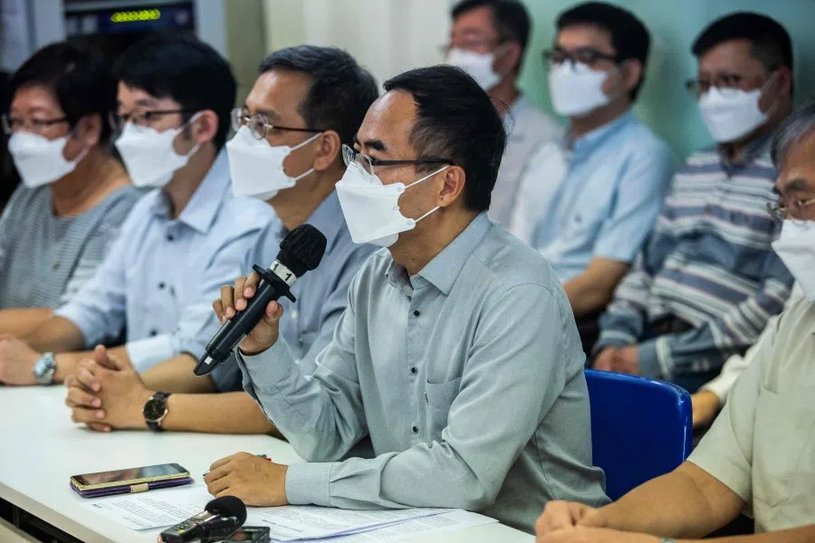 HKPTU president Fung Wai-wah (centre) speaks at a press conference in Hong Kong on 10 August 2021 about the union's dissolution, citing "huge pressure" as authorities stamp out the city's democracy movement and impose political orthodoxy on the finance hub. (Isaac Lawrence/AFP)