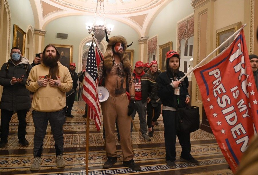 In this file photo from 6 January 2021, supporters of US President Donald Trump enter the US Capitol, in Washington, DC. (Saul Loeb/AFP)