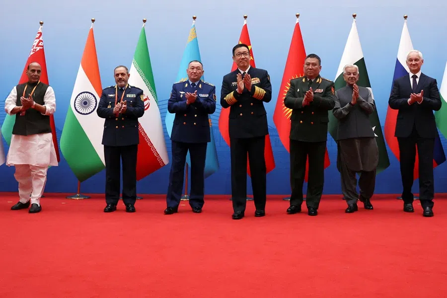 Chinese Defence Minister Dong Jun, India’s Defence Minister Rajnath Singh, Iran’s Defence Minister Aziz Nasirzadeh, Kazakhstan’s Defence Minister Dauren Kosanov, Kyrgyzstan’s Defence Minister Ruslan Mukambetov, Pakistan’s Defence Minister Khawaja Asif and Russia’s Defence Minister Andrei Belousov applaud following a group photo, before the Shanghai Cooperation Organisation (SCO) Defence Ministers’ Meeting in Qingdao, Shandong province, China, on 26 June 2025. (Florence Lo/Reuters)