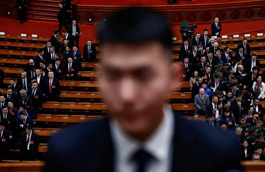 A security personnel stands guard as delegates leave following the second plenary session of the National People's Congress (NPC) at the Great Hall of the People in Beijing, China, on 9 March 2026.